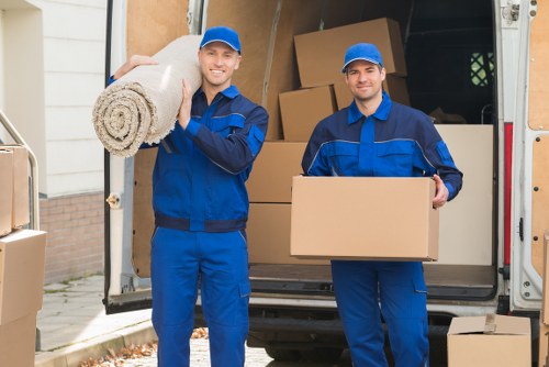 Uxbridge Movers team sorting recyclable packing materials beside a moving van