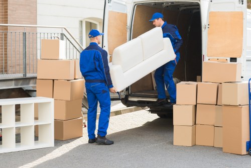 Professional movers handling furniture in a local Uxbridge home